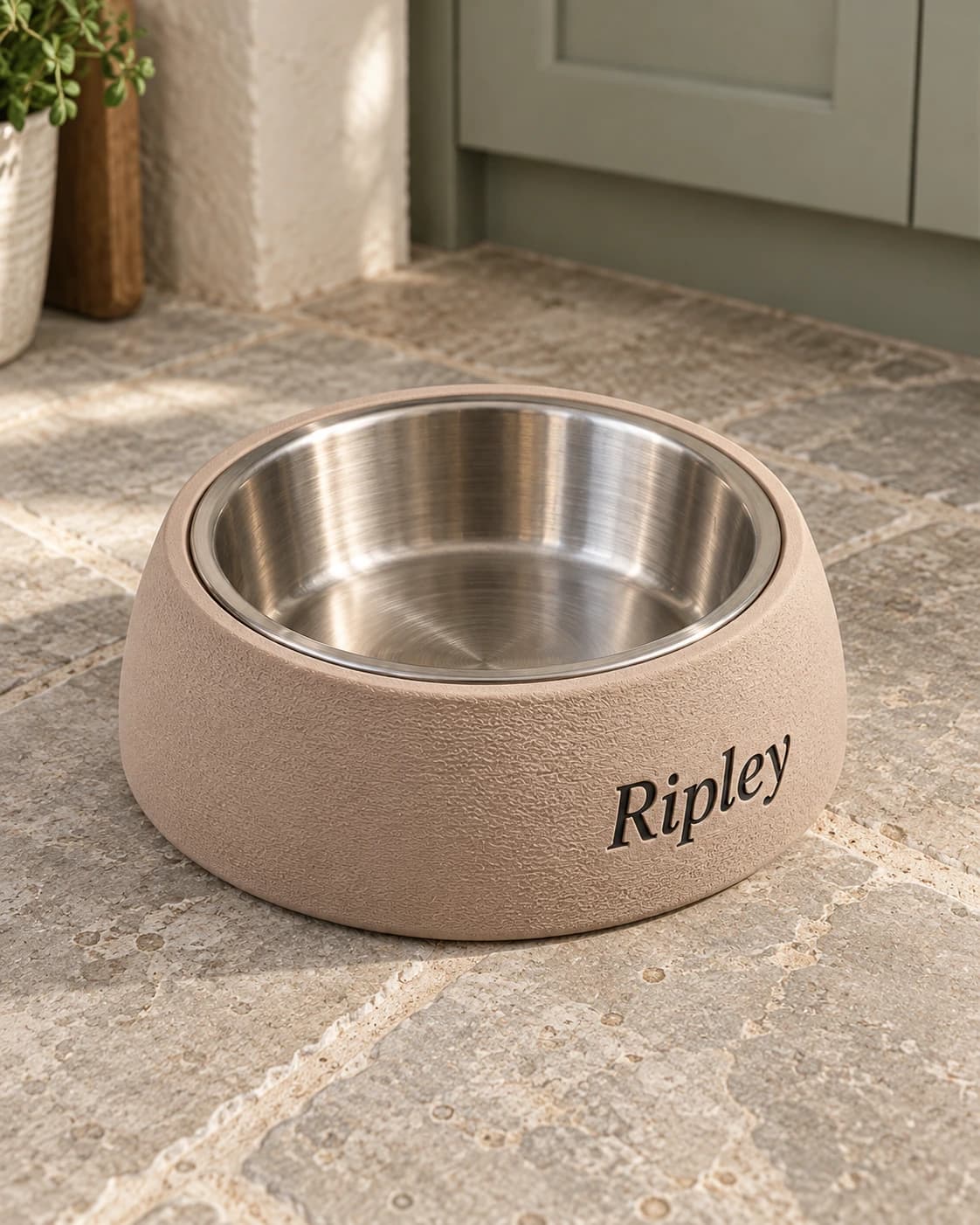 Ripley's latte-coloured curved bowl stand with black lettering on the limestone floor of a cottage kitchen